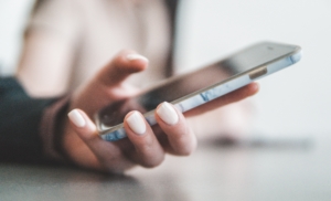 Woman holding a phone - Lafora disease tip about who to contact