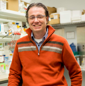 Headshot of Dr. Matthew Gentry smiling, in a lab