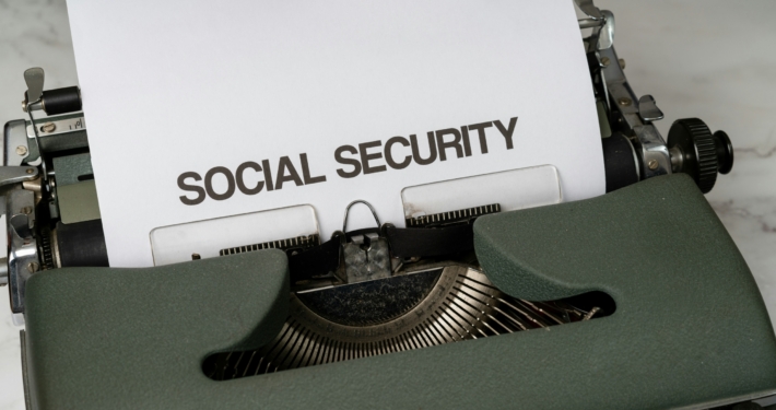 text says "social security" on a piece of paper in a typewriter