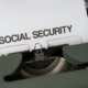 text says "social security" on a piece of paper in a typewriter